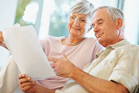 Photo of a couple looking at papers. Link to Closely Held Business Stock. Photo of a couple looking at papers. Link to Closely Held Business Stock.